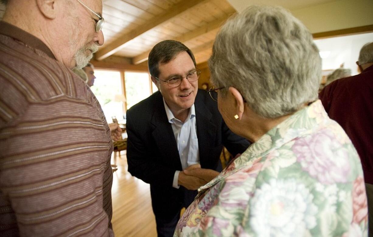 Denny Heck greets Mac and Pat Echols, who now live in the Vancouver house where he grew up, during a Lake Shore neighborhood campaign event in early June.