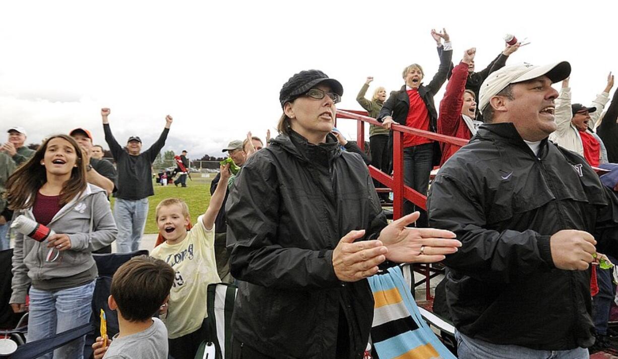 Krista Colvin and her husband, Mike, cheer on Wes during a Little League playoff game.