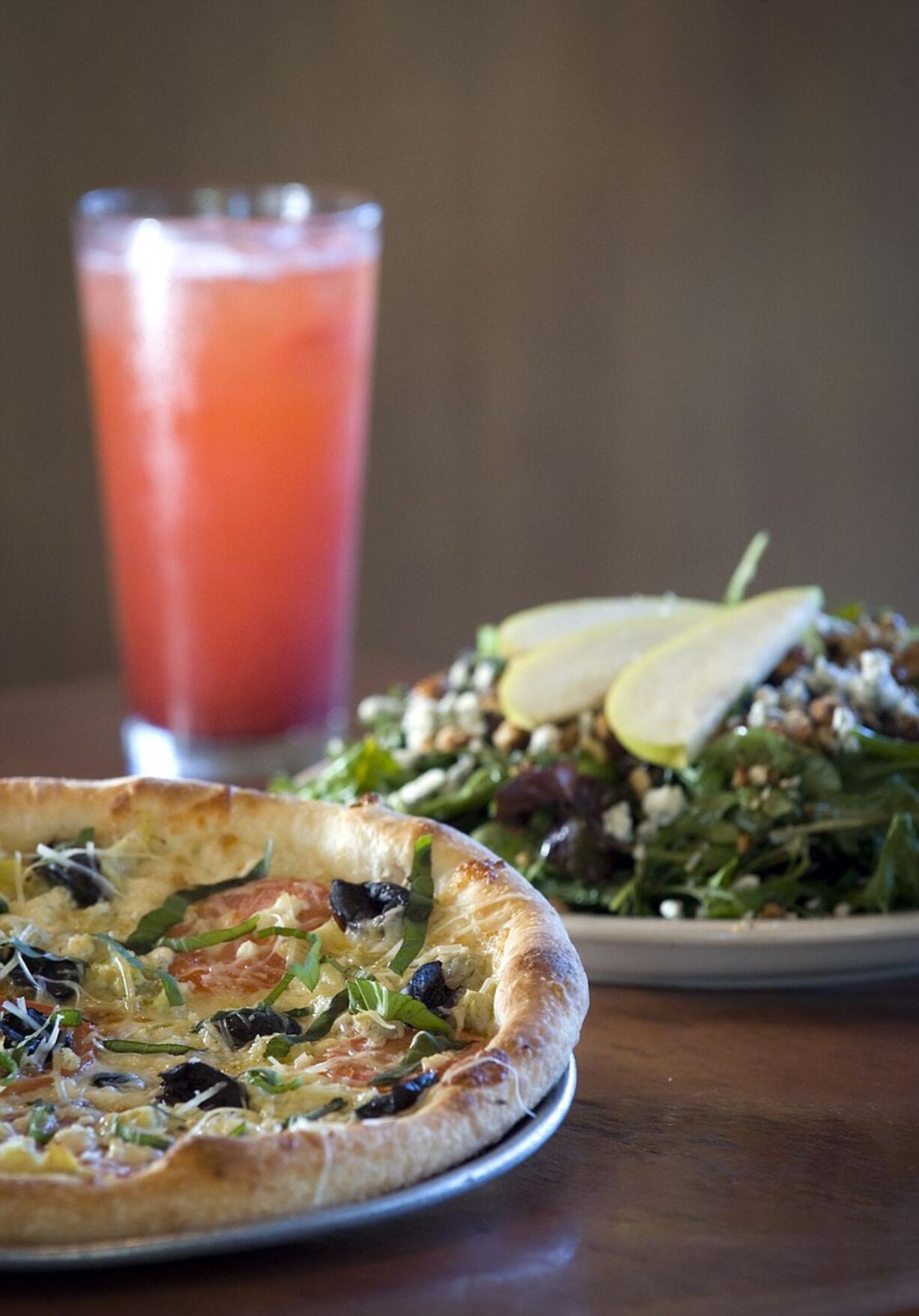 Pizzicato's vegetarian Puttanesca pizza begins with a garlic-and-olive-oil base and is topped with tomatoes, artichoke hearts, kalamata olives, feta and mozzarella.