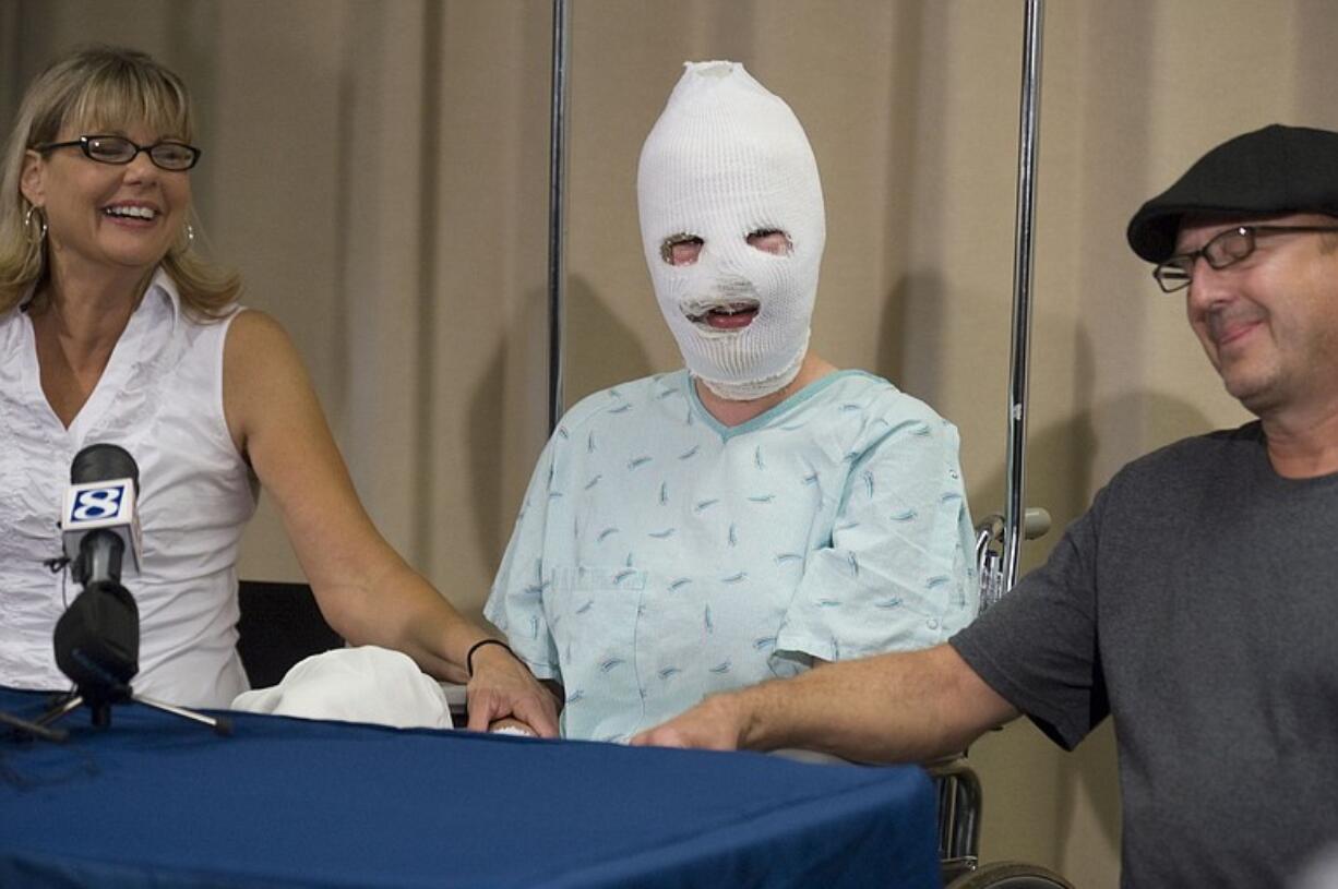 Bethany Storro, who was a victim of a random attack near Esther Short Park earlier in the week, is flanked by her parents Nancy and Joe Neuwelt, during a press conference at Legacy Emanuel Hospital in Portland on Thursday.