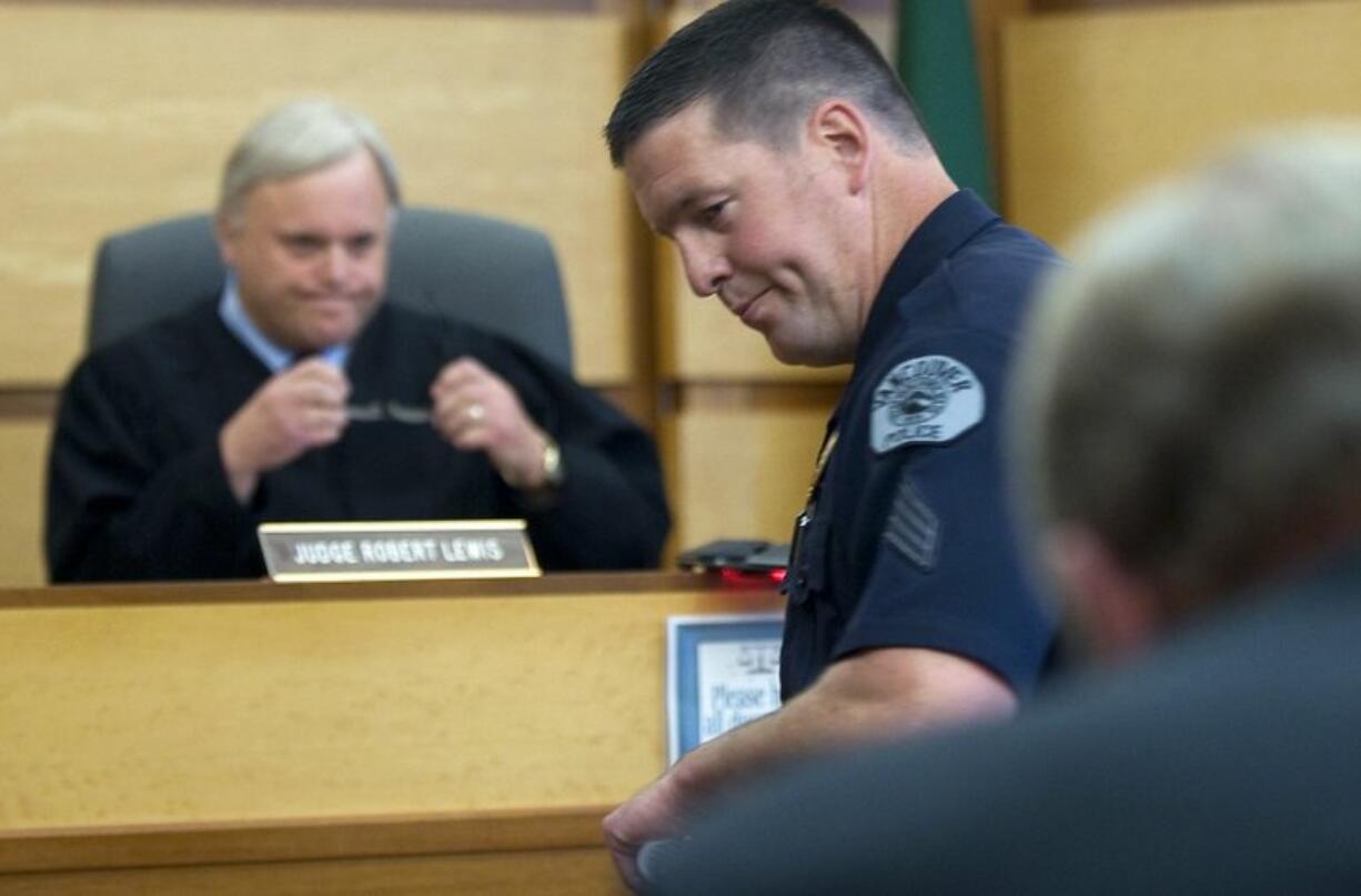 Vancouver police Sgt. Jay Alie addresses the judge Friday during a sentencing hearing for two Portland men who shot him in April 2009 when he stopped their car after a home-invasion robbery.