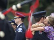 Carsen Yela, 7, of Vancouver, kisses her father, Vancouver firefighter Joe Yela, during a Sept. 11, 2010 flag ceremony to observe the ninth anniversary of Sept. 11, 2001.