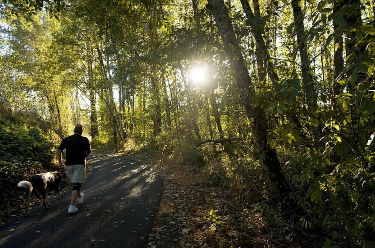 Tim Hammond and his dog Ozzie use the new Washougal River Greenway Trail in Camas.