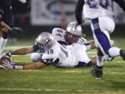 Heritage's Andy Bemis (10) recovers a fumble against Skyview in the first half at Kiggins Bowl on Friday.