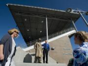 Doreen McKercher, from left, Doug Quinn and Heidi Rosenberg check out a new statue of Doc Harris at the newly remodeled Doc Harris Stadium in Camas.