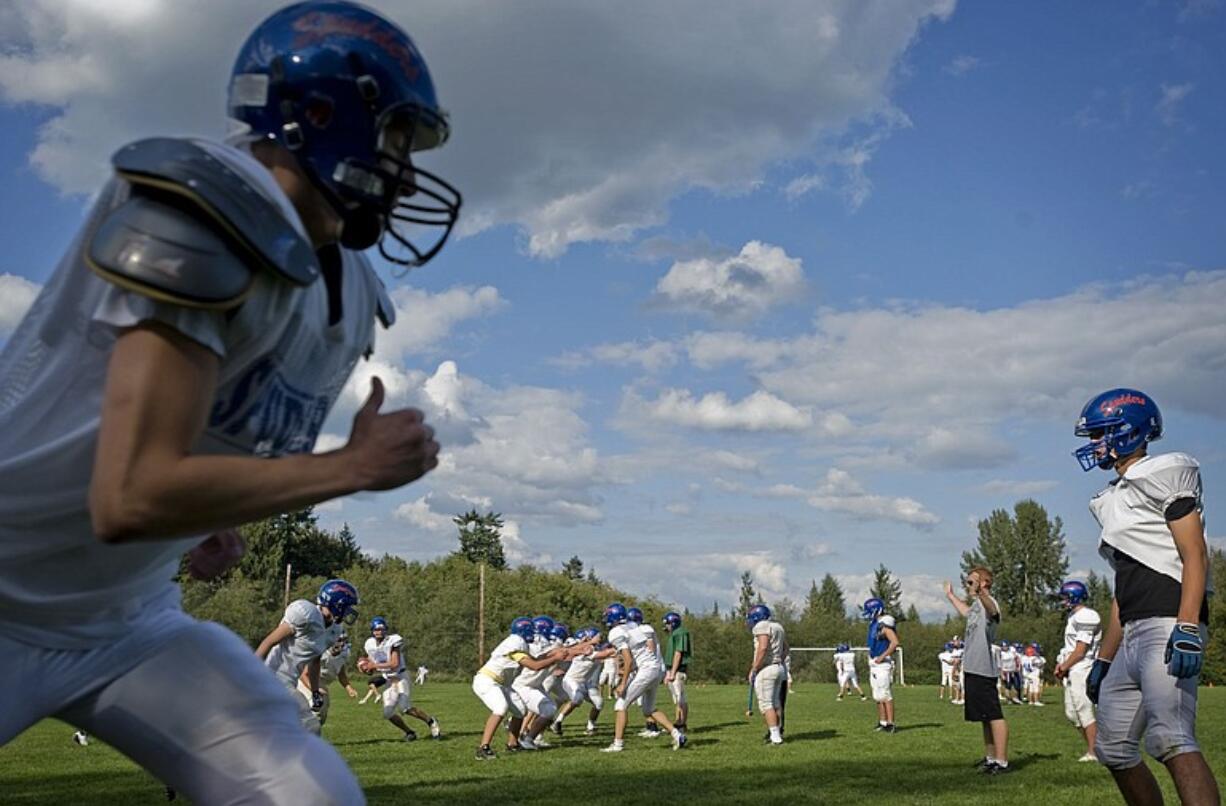 Ridgefield High School's football team gets ready for its Trico League matchup against La Center tonight.