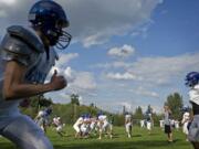 Ridgefield High School's football team gets ready for its Trico League matchup against La Center tonight.