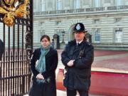 Rachel Sedaker stands with a pair of Buckingham Palace guards during her visit to London.