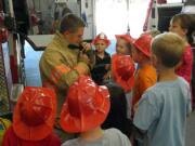 Kevin Stromberg, a firefighter-paramedic, demonstrated how to suit up.