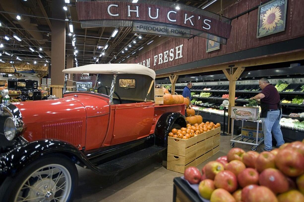 Chuck's Produce &amp; Street Market Produce Manager Paul Todak, right, hustles as he stocks produce in preparation for the impending grand opening.