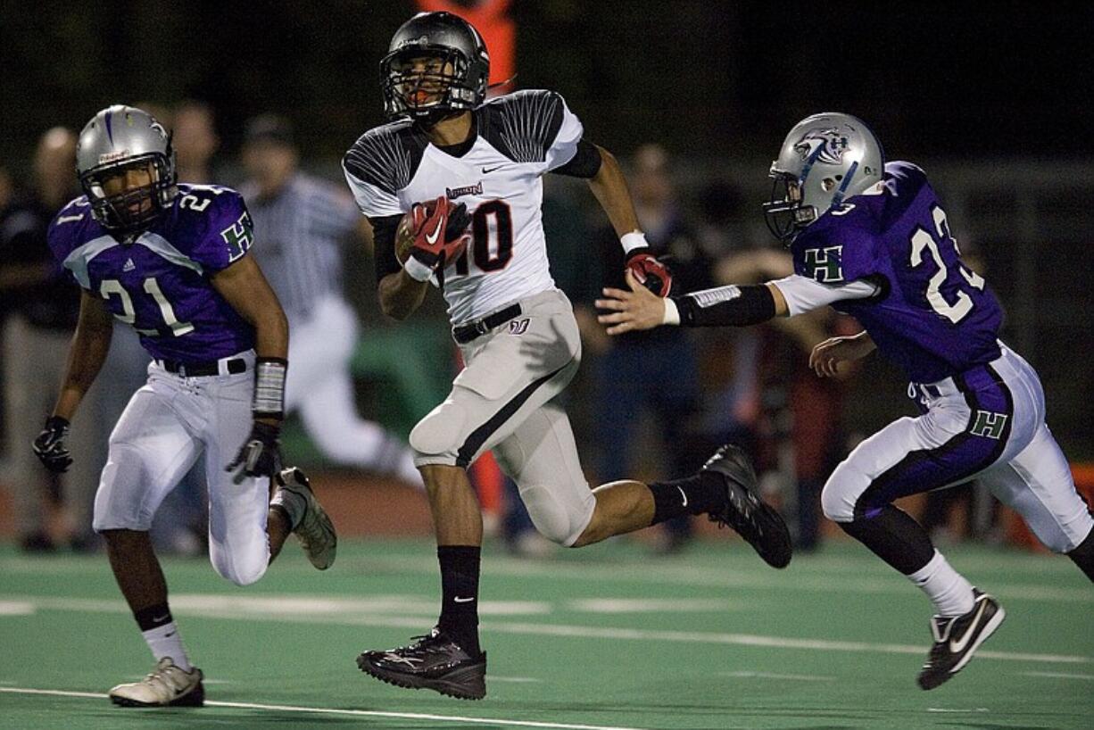 Union's Tre Christensen splits two Heritage defenders during the Titans' 56-14 win over the Timberwolves Friday.