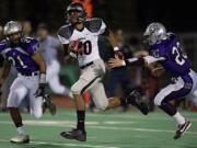 Union's Tre Christensen splits two Heritage defenders during the Titans' 56-14 win over the Timberwolves Friday.