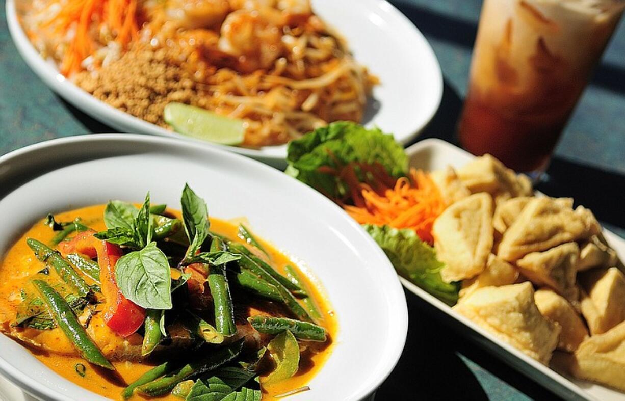 Clockwise from top: Pad Thai, Thai Iced Tea, Fried Tofu with Peanut Sauce and Panang Curry at Thai Little Home.