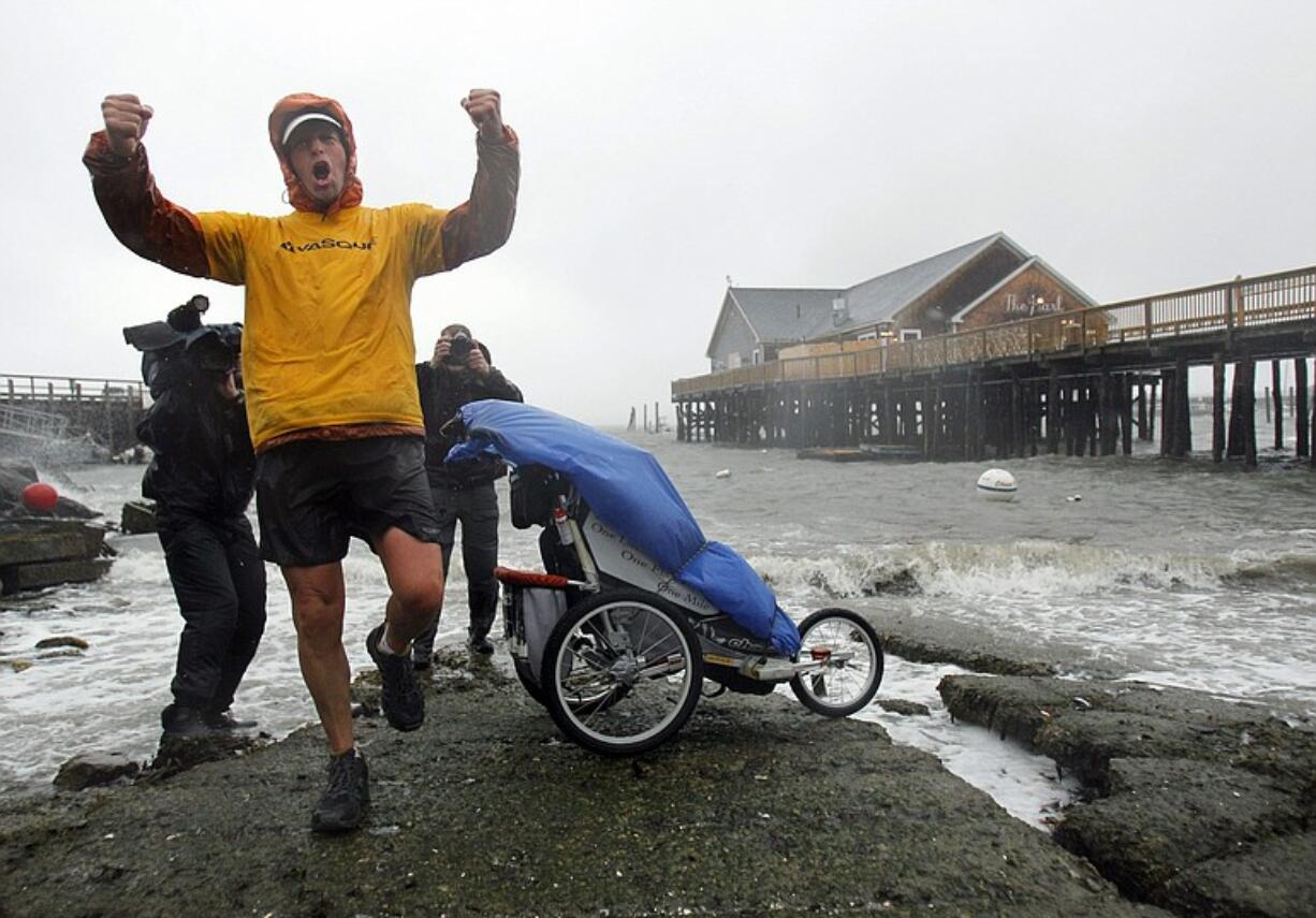 Mike Ehredt of Hope, Idaho, celebrates the completion of his 4,425-mile coast-to-coast run Friday in Rockland, Maine.