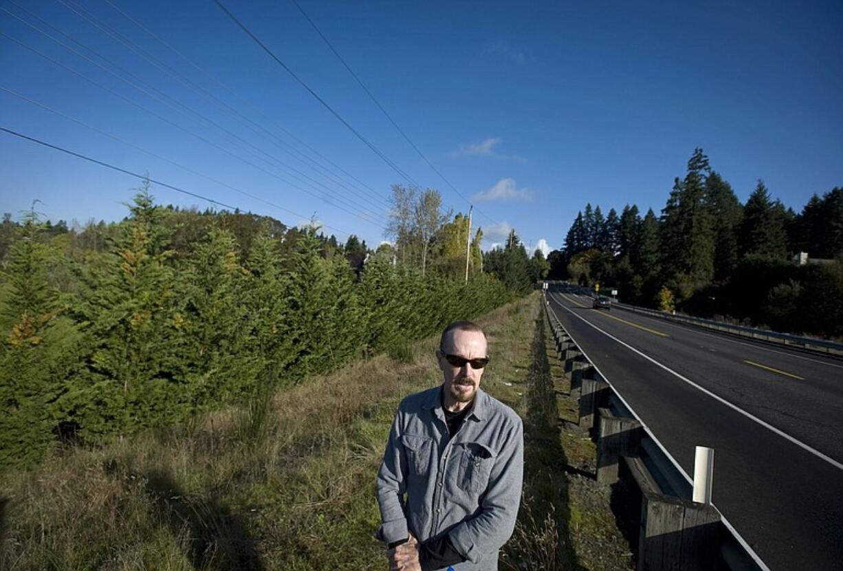 David Leonhardt stands near the a line of cypress trees that he said mysteriously appeared in the spring of 2009.