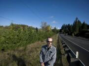 David Leonhardt stands near the a line of cypress trees that he said mysteriously appeared in the spring of 2009.