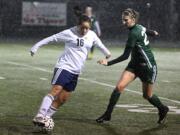 Gabrielle Burrell of Hockinson, left, keeps the ball away from a Sehome High defender during the first round of the Class 2A girls soccer state playoffs at Battle Ground High Schoo.