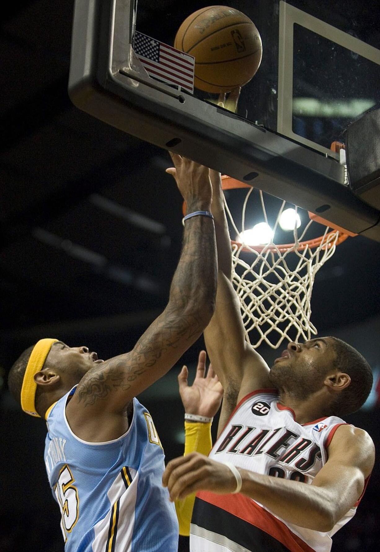 Portland's Nicolas Batum blocks the shot of Denver's Carmelo Anthony in the first quarter Thursday.