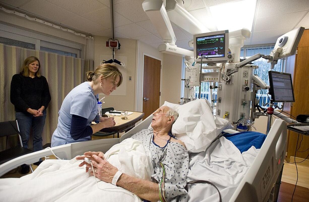 Patient David Hall is cared for by nurse Rebecca Holcomb in the intensive care unit at PeaceHealth's St.