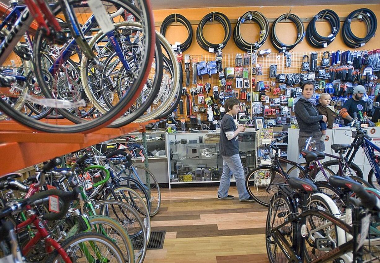 Heather Fray, right, of Vancouver browses with her two sons, Boden, 10 months and Max, 9, at Bad Monkey Bikes Board &amp; Skate shop in downtown Vancouver.