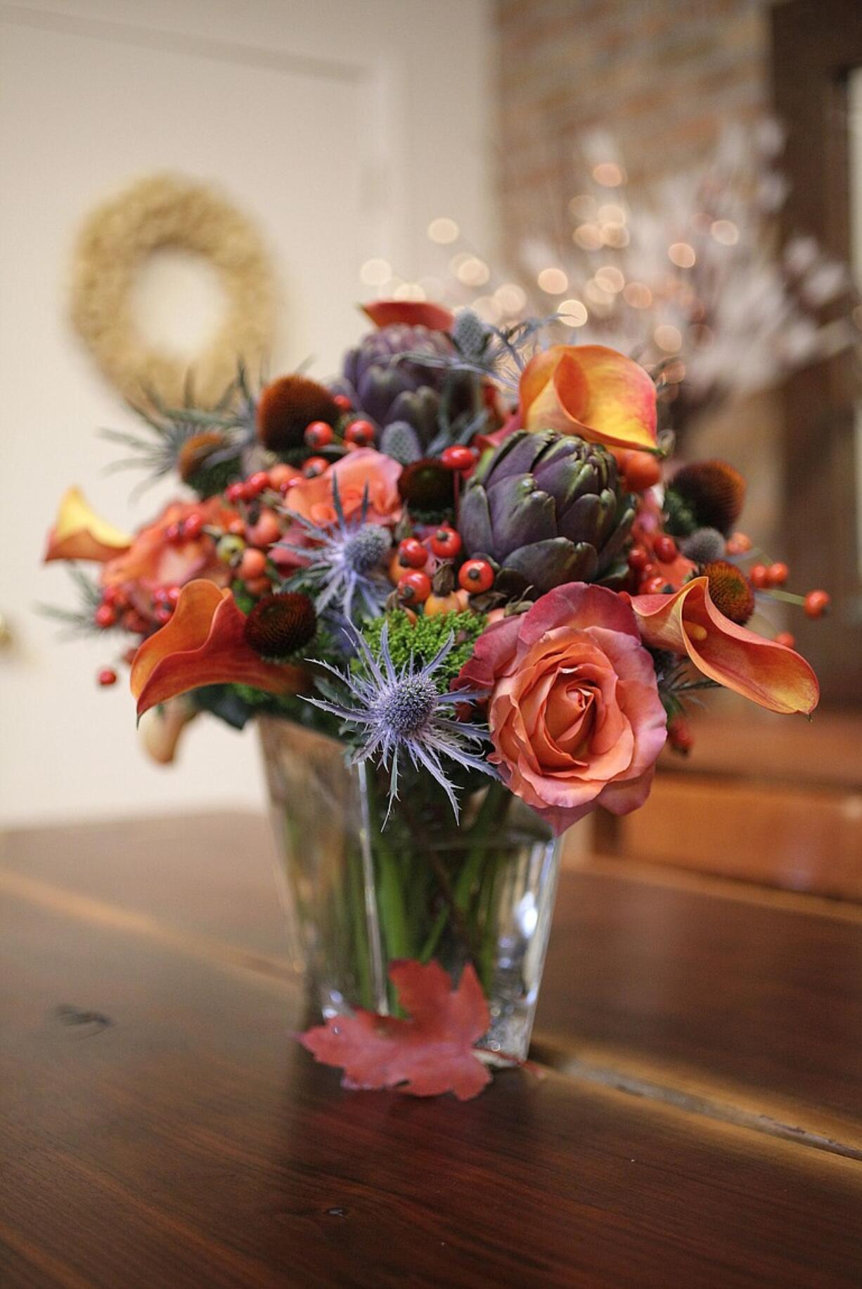 Sea holly, &quot;Coffee Break&quot; rose, calla lilies and cranberry rosehips share starring roles in this bouquet.