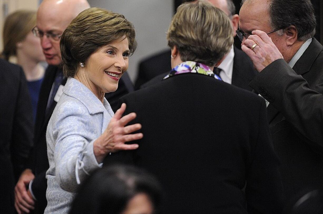 Former First Lady Laura Bush visits with guests at a private reception Tuesday before her speech at the Hilton Vancouver Washington.