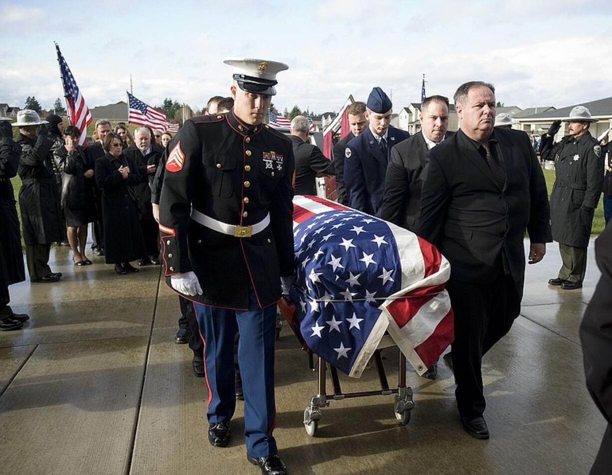 The body of Marine Sgt. Jason D. Peto is escorted Saturday into Holy Redeemer Catholic Church in Vancouver. Sgt.