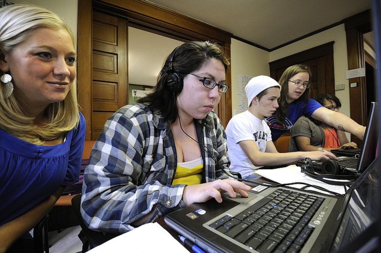 Anna Lookingbill, left, a resource coordinator with Juvenile Recovery Court, helps Crystal Cook, 19, a student at Summit View Alternative School, with her video project.