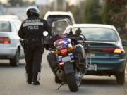 Vancouver Police Officer John Davis issues a speeding ticket to a driver.