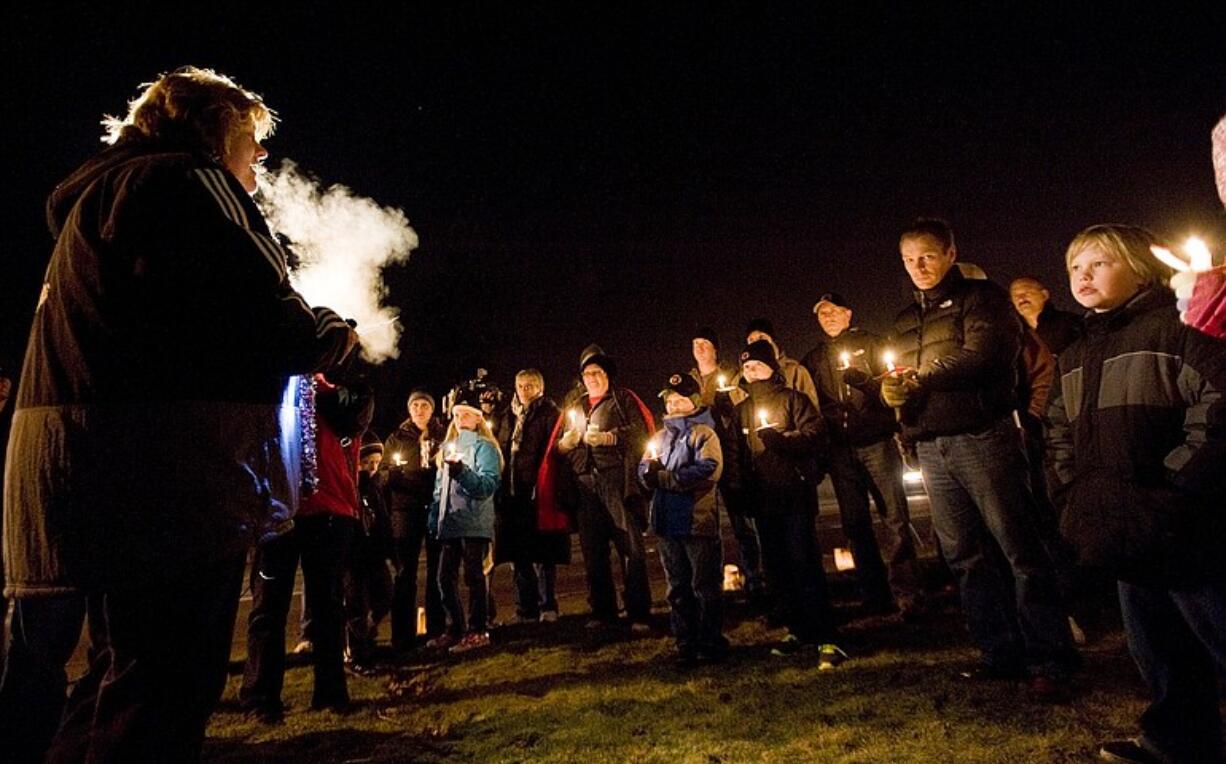 Mary Elkin, founder of Friends of Fire Station 6, speaks to supporters, including firefighters and their families, during a candelight vigil at the central Vancouver station on Thursday evening.