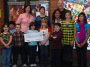 Ogden: Fifth-grade students with their teacher, Michael Wood, present some help to Rachel Leland of the Vancouver Division of the Portland Veterans Affairs Medical Center.