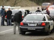 Police transport a bank robbery suspect after a chase in the eastbound lanes of state Highway 14 Tuesday January 11, 2011.