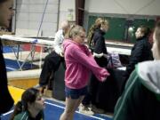 Jessica Heron stretches out a yawn while waiting for other team mates to start gymnastics practice Tuesday morning.  The Evergreen High School gymnastics team meets  at 5:15 am, 4 days a week, for practice at Vancouver Elite Gymnastics Academy.