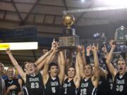 The Union boys basketball team hoisted the Class 3A state championship trophy after a win over Enumclaw last season.