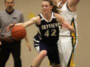 Skyview center Katie Swanson (42) reaches for the ball as Evergreen forward Tori Conley (R) defends during first half of girl's basketball game at Evergreen.