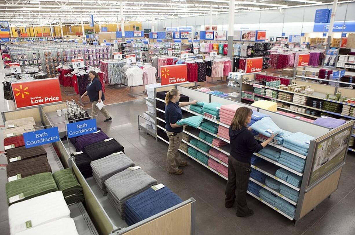 Julie Benson of Ridgefield stocks towels at the Woodland Walmart, which is set to open Wednesday.