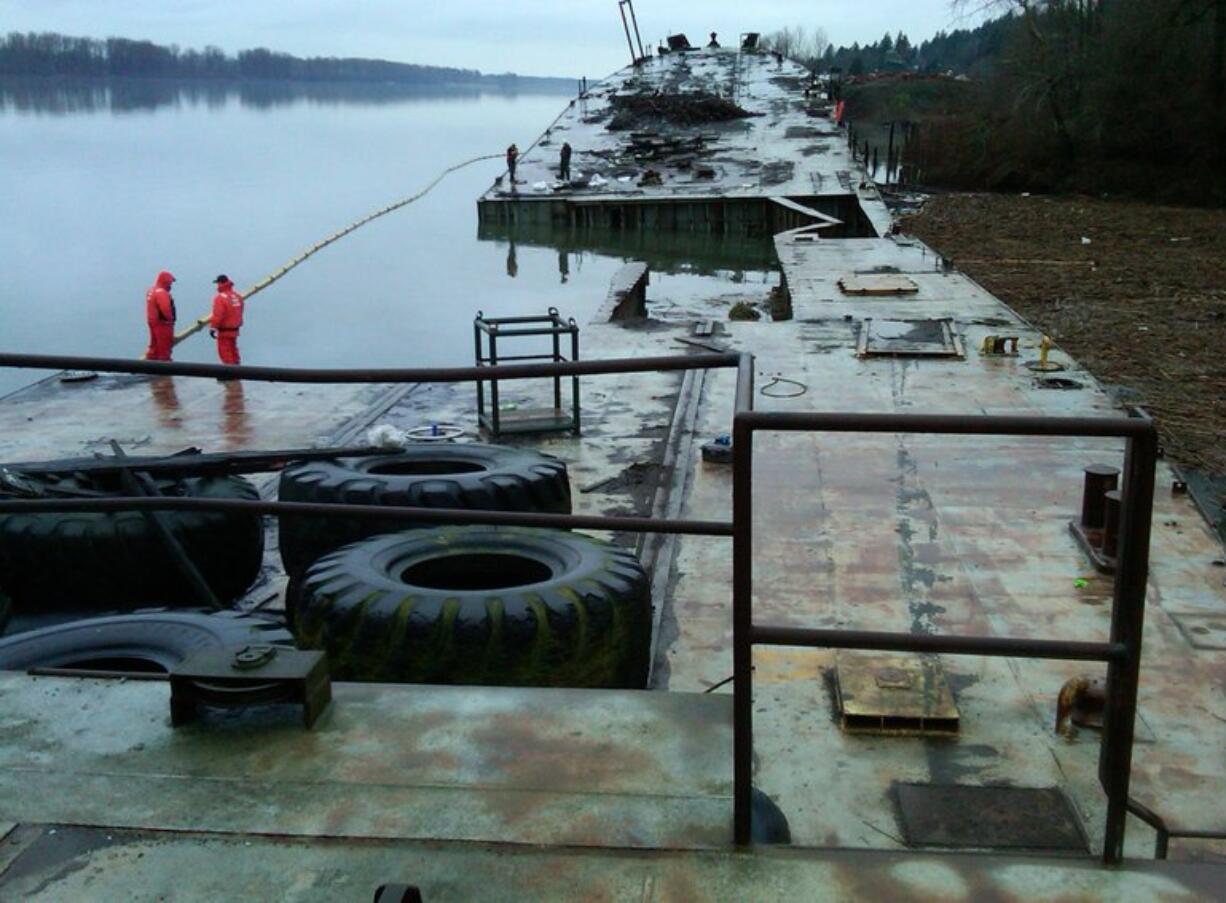 The beached former Liberty ship Davy Crockett sits aground in Vancouver as workers survey the vessel and remove oil last weekend.