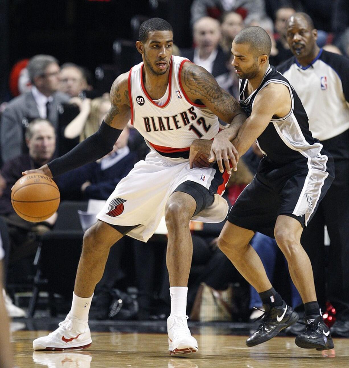 San Antonio Spurs' Tony Parker defends against Portland Trail Blazers' LaMarcus Aldridge (12) during the first quarter of an NBA basketball game Tuesday, Feb. 1, 2011, in Portland, Ore.