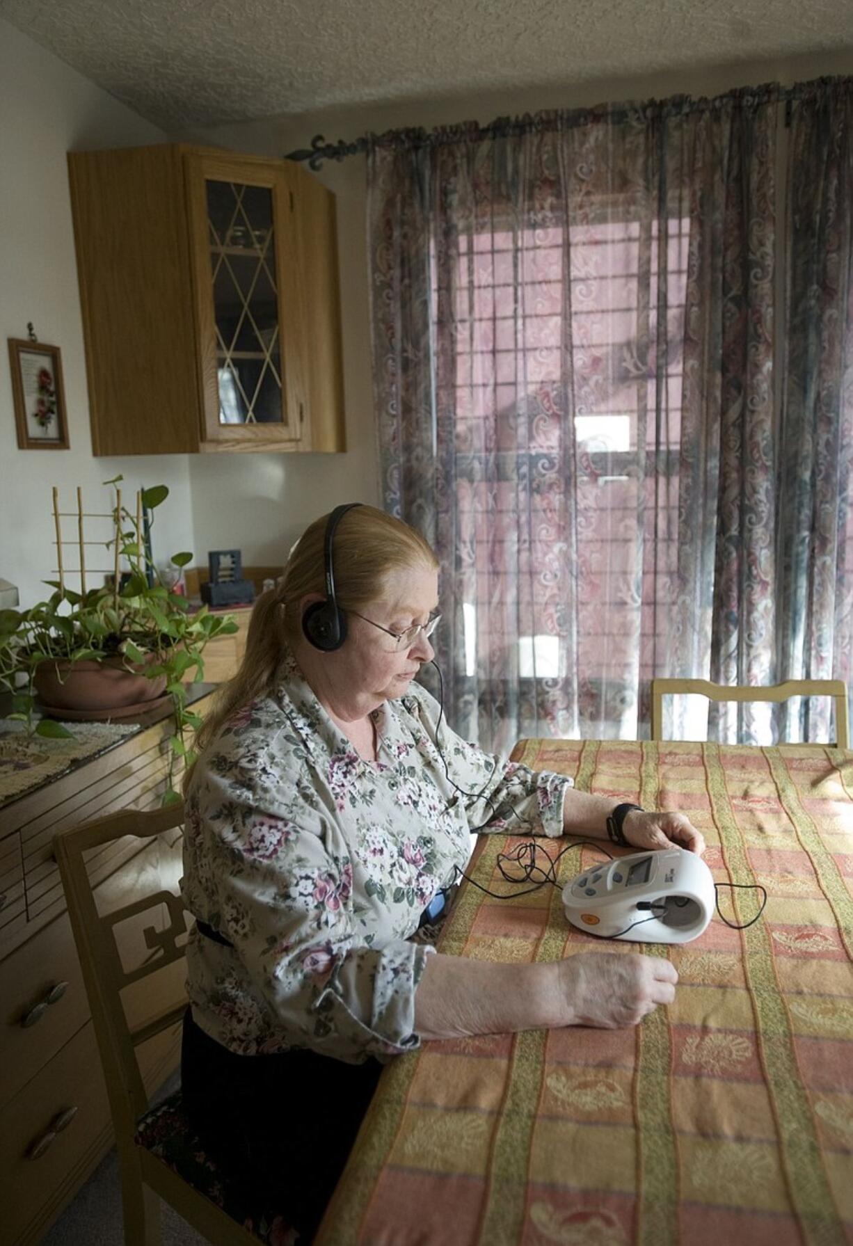 Licensed practical nurse Yvonne Fowler of Vancouver demonstrates how she uses Resperate, a device that coaches her through breathing exercises.