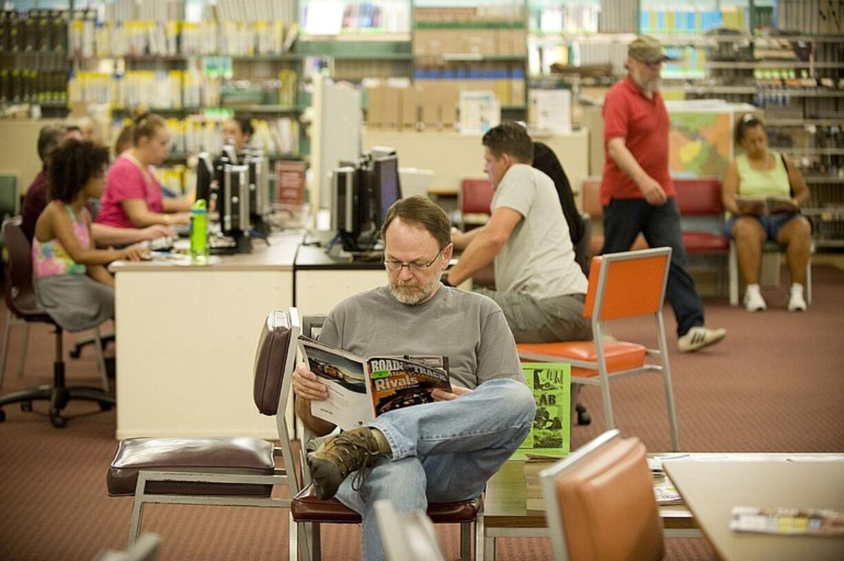 Roger O'Connor of Vancouver reads a magazine at the soon-to-be-replaced Vancouver Community Library.