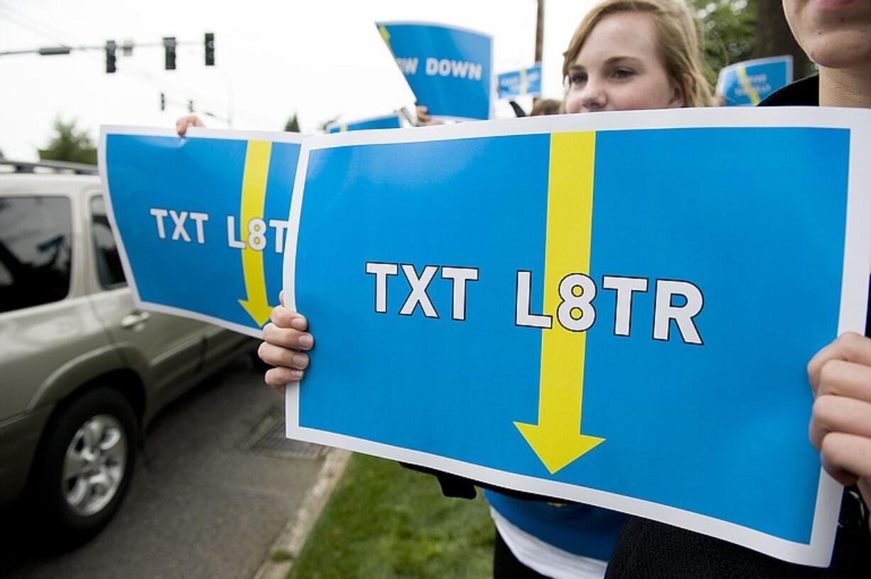 Seton Catholic College Preparatory High School sophomores raise awareness of dangers of texting while driving, outside the 112th Avenue campus.