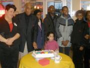 Val Martinez, Krispy Kreme general manager, left, helps Harold Franklin and his family celebrate Franklin's retirement after 7 years at the doughnut shop.