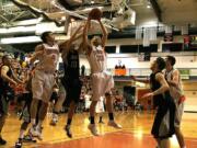 Battle Ground forward Seth Belknap (33) pulls down a rebound against Union during the Titans' Class 4A playoff victory on Friday night.