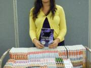 Jen Studebaker, young adult services coordinator at the Vancouver Barnes &amp; Noble, sorts through books donated by the community to the Fort Vancouver Library Foundation.