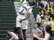 Warren Edmondson of Evergreen High takes the ball to the hoop during the Class 4A bi-district playoff game Thursday at Evergreen.