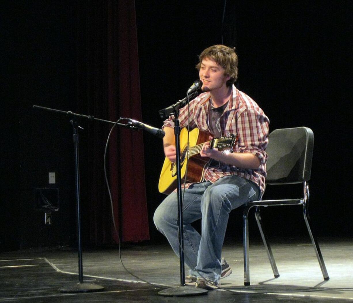 Ron Stackpole plays acoustic guitar during the Talent Show at Evergreen High School.