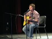 Ron Stackpole plays acoustic guitar during the Talent Show at Evergreen High School.