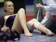 Columbia River's Jordan Hess competes on the uneven bars with a torn ACL  at the 2011 WIAA Gymnastics Tournament in Tacoma, Friday, February 18, 2011.(Steven Lane/The Columbian)