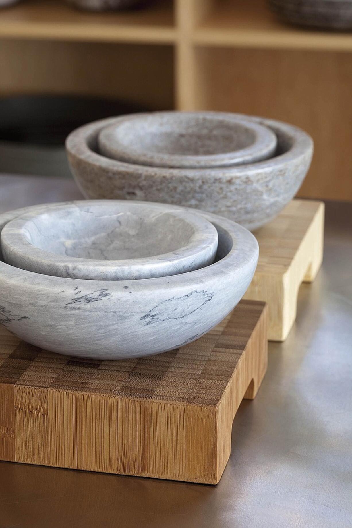 Eighteen Karat creates these honed marble bowls.