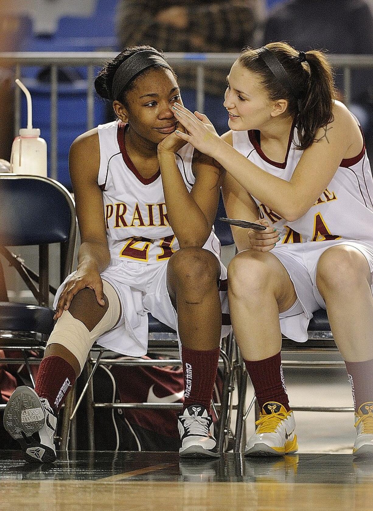 Prairie's Lynn Idelberger, right, wipes a tear away from the face of teammate Lanae Adams. Adams left Friday's game with a sore knee and did not return.